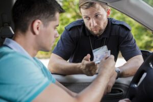 PolicemanCheckingYoungMaleDriversDocuments