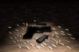 andgun placed on a law enforcement evidence table, representing firearm-related criminal charges.