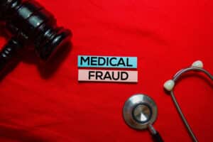 MedicalFraudTextOnStickyNotesWithStethoscopeAndGavel
