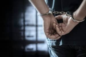 ArrestedManInHandcuffsWithHandcuffedHandsBehindBackIn