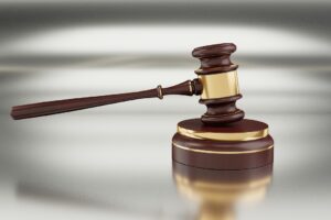 Judge’s gavel on a reflective surface, symbolizing probation violations, revocation hearings, and criminal court proceedings in Texas.