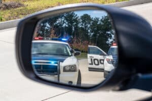 TwoPoliceVehiclesStopASedanOnARoutineTraffic