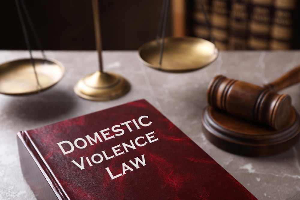 DomesticViolenceLawAndGavelOnGreyMarbleTableCloseup