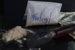 DollarBillsAndAFentanylPowderPackWithASyringe