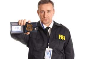 MatureFbiAgentShowingDocumentOnWhiteBackground