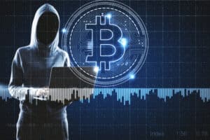 HackerWithLaptopAndBitcoinSignCryptocurrencyAndHackingConcept