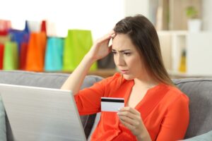 WorriedShopperBuyingOnlineWithCreditCardSittingOnA