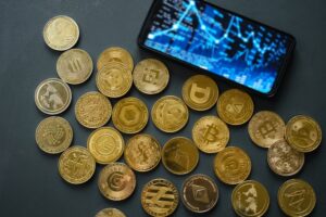 VariousCryptocurrencyCoinsLayScatteredOnADarkTableA